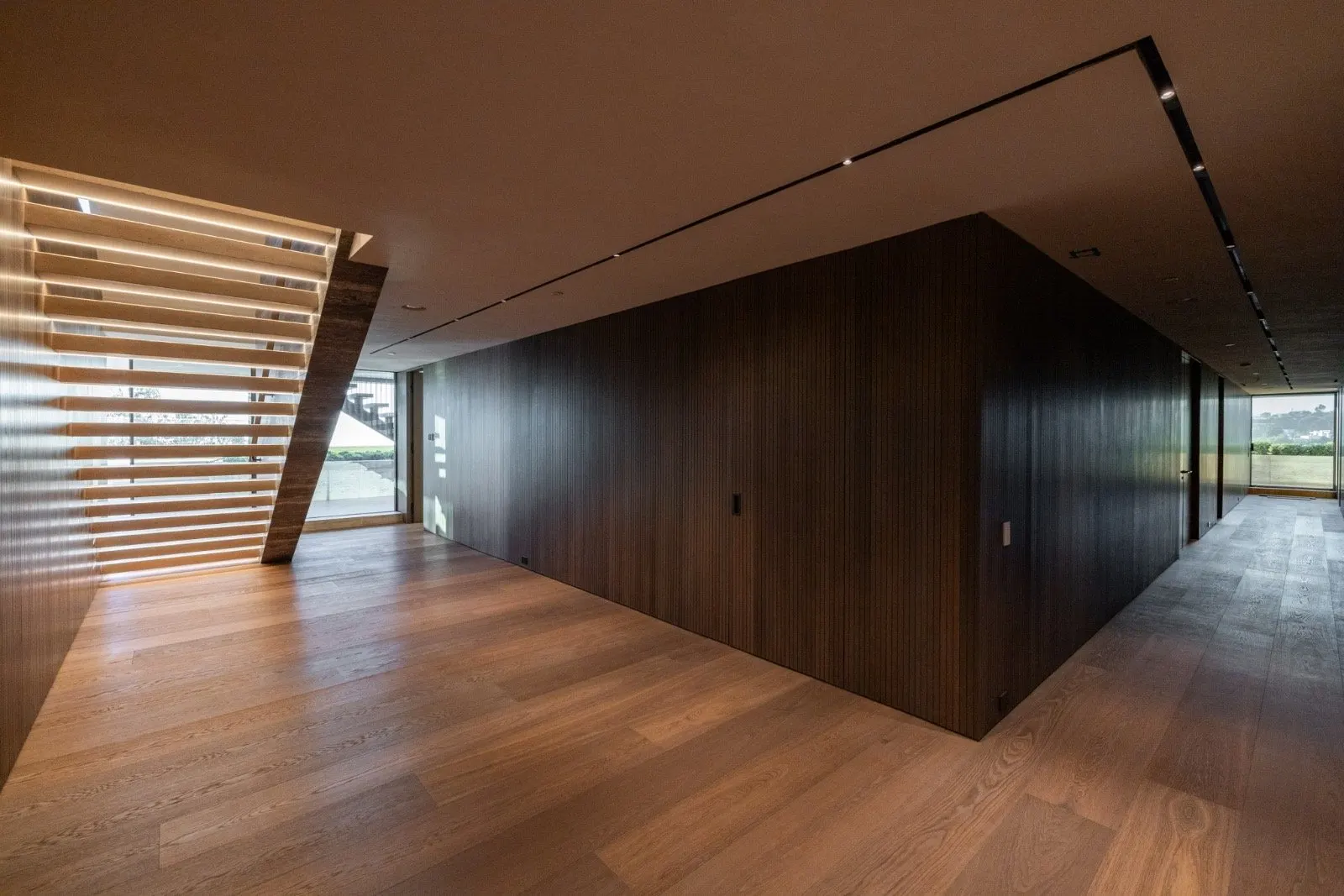 The Getty House — 684Firth Brentwood CA LA Upper Hallway Wood Panels Hardwood Floor Linear Lighting Slatted Window  Modern Home