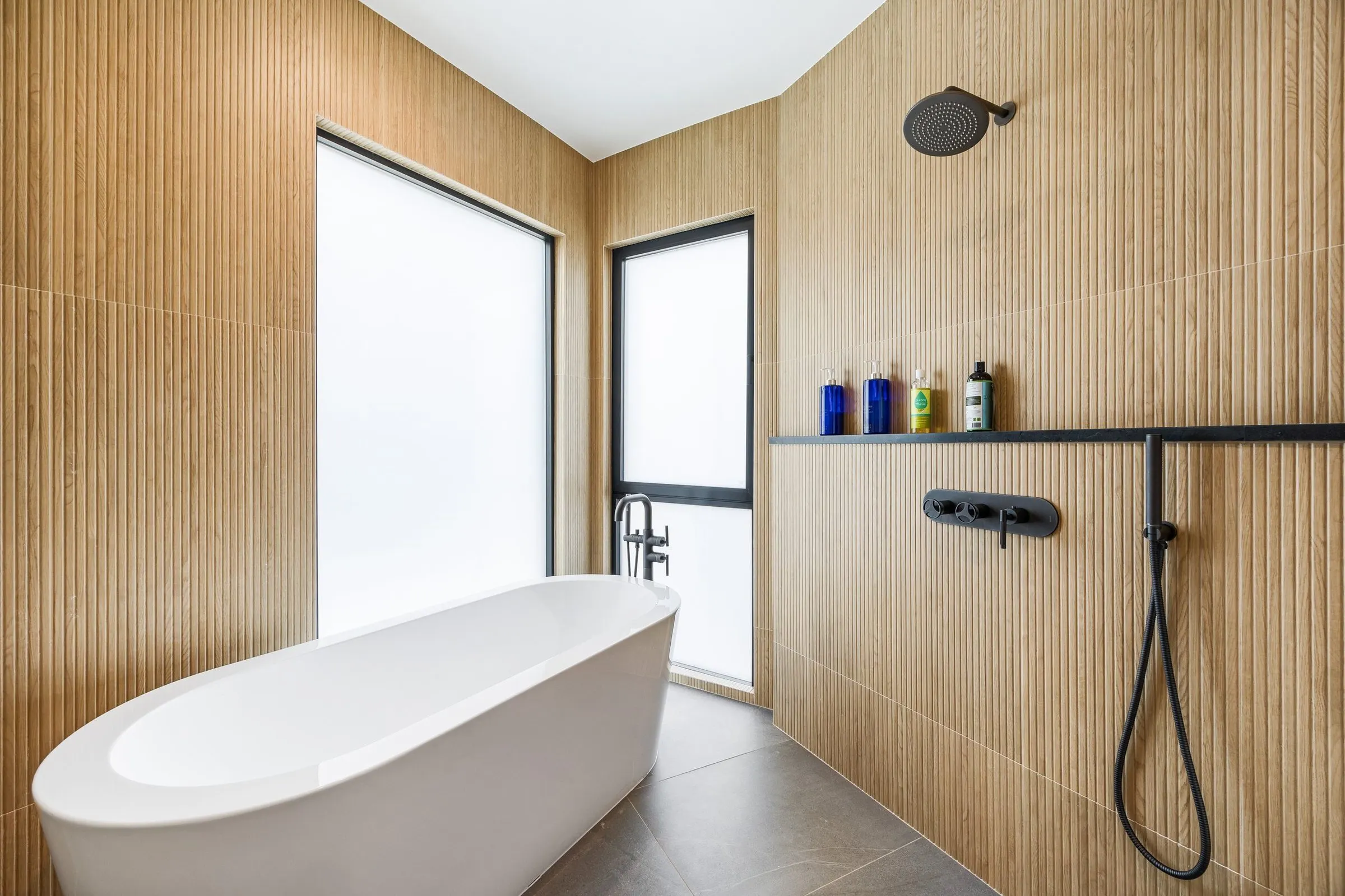 Benloch Ranch Lot 134 — bathroom with wood slats, freestanding tub, oak detailing