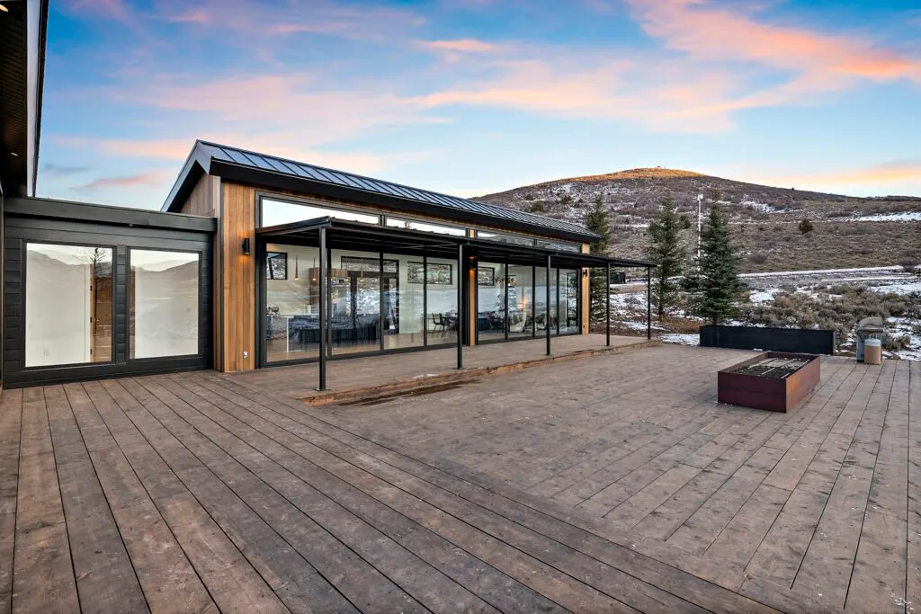 Icon Haus — covered wood deck with fire pit and mountain view