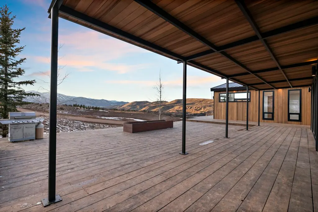 Icon Haus — covered outdoor kitchen and deck framing the mountains