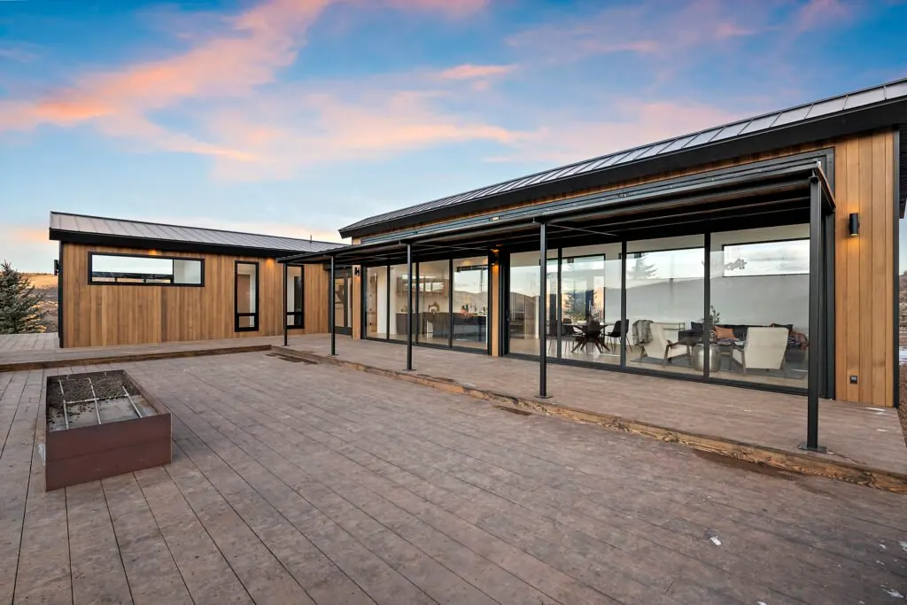 Icon Haus — covered patio and wood deck at sunset