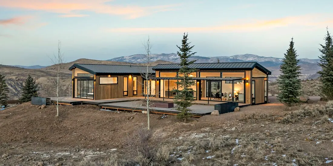 Icon Haus — hillside view of the wood-and-glass façade above Benloch Ranch