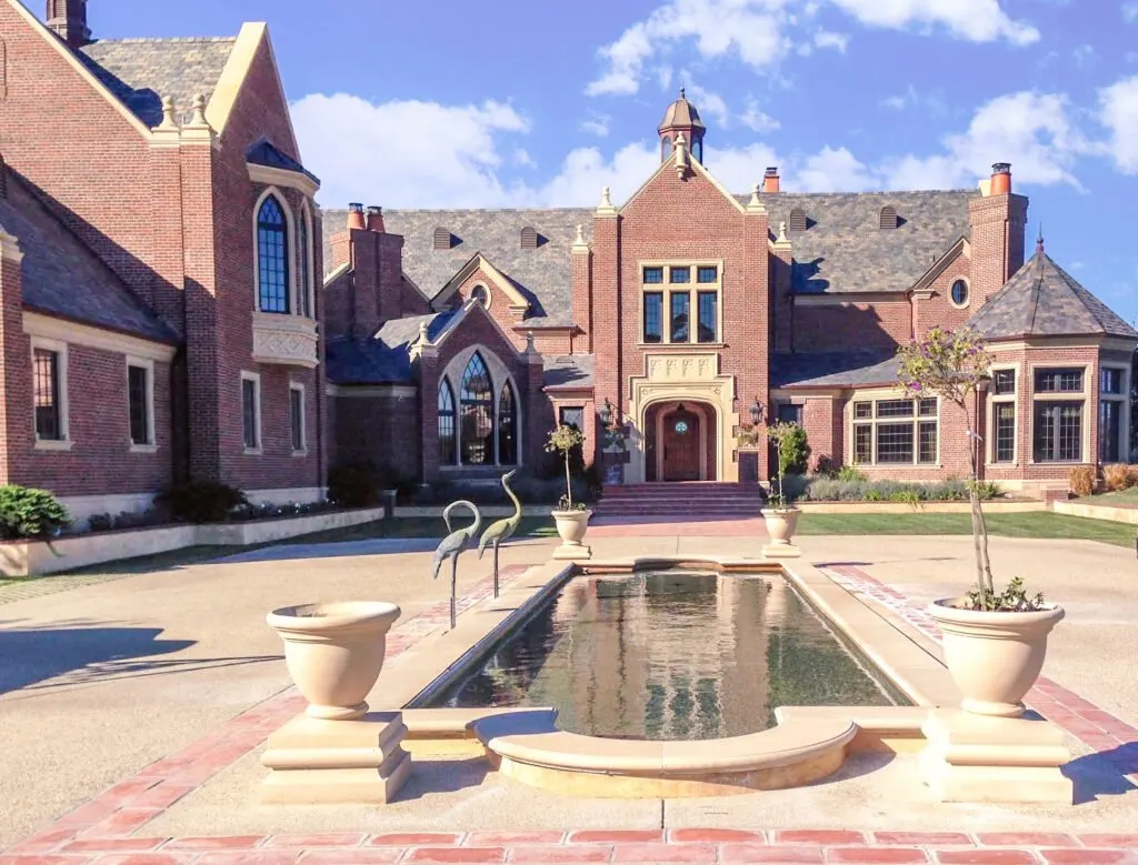 White Stallion — covered brick front entry of the English Tudor estate