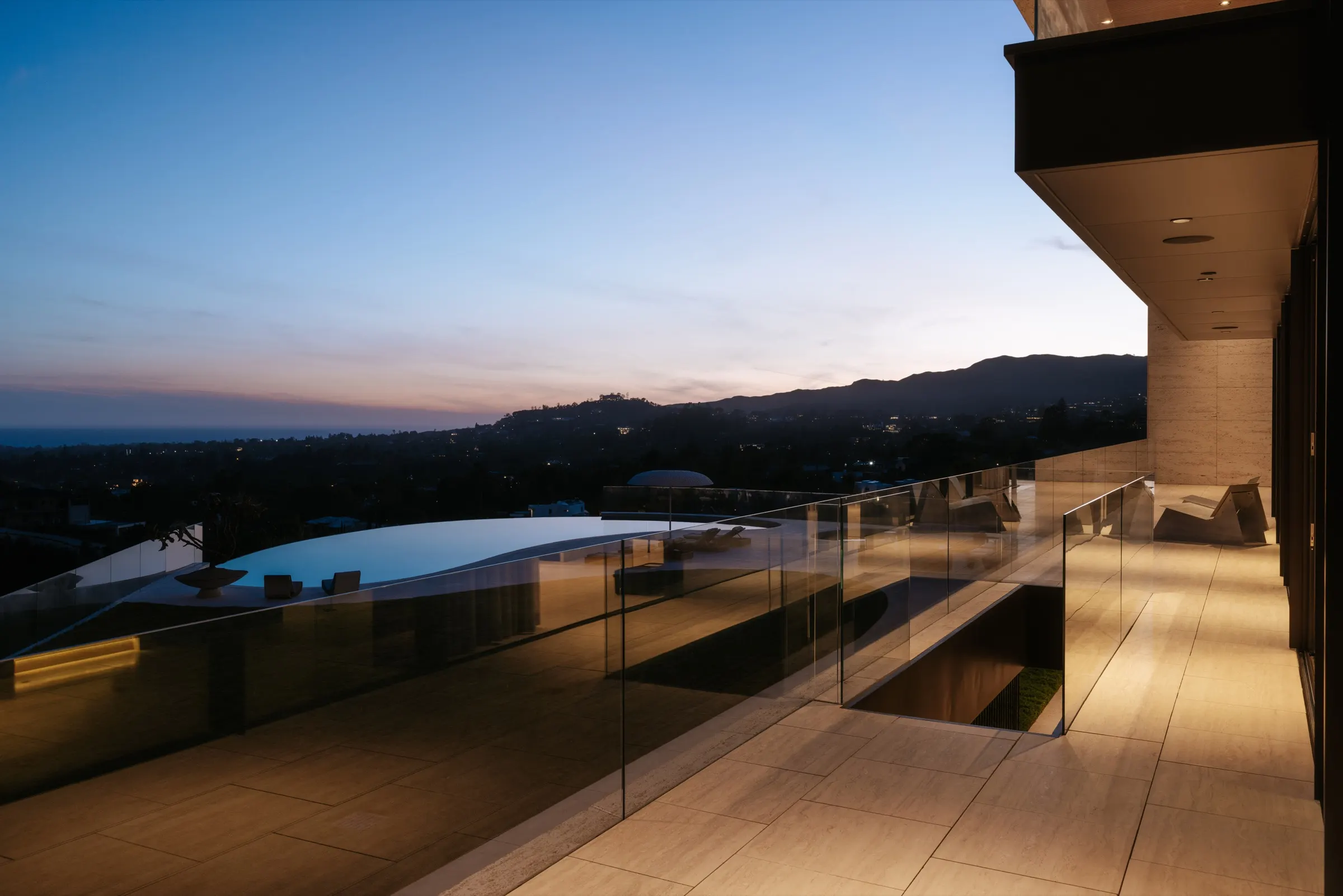The Getty House, Brentwood — balcony at dusk over the infinity pool