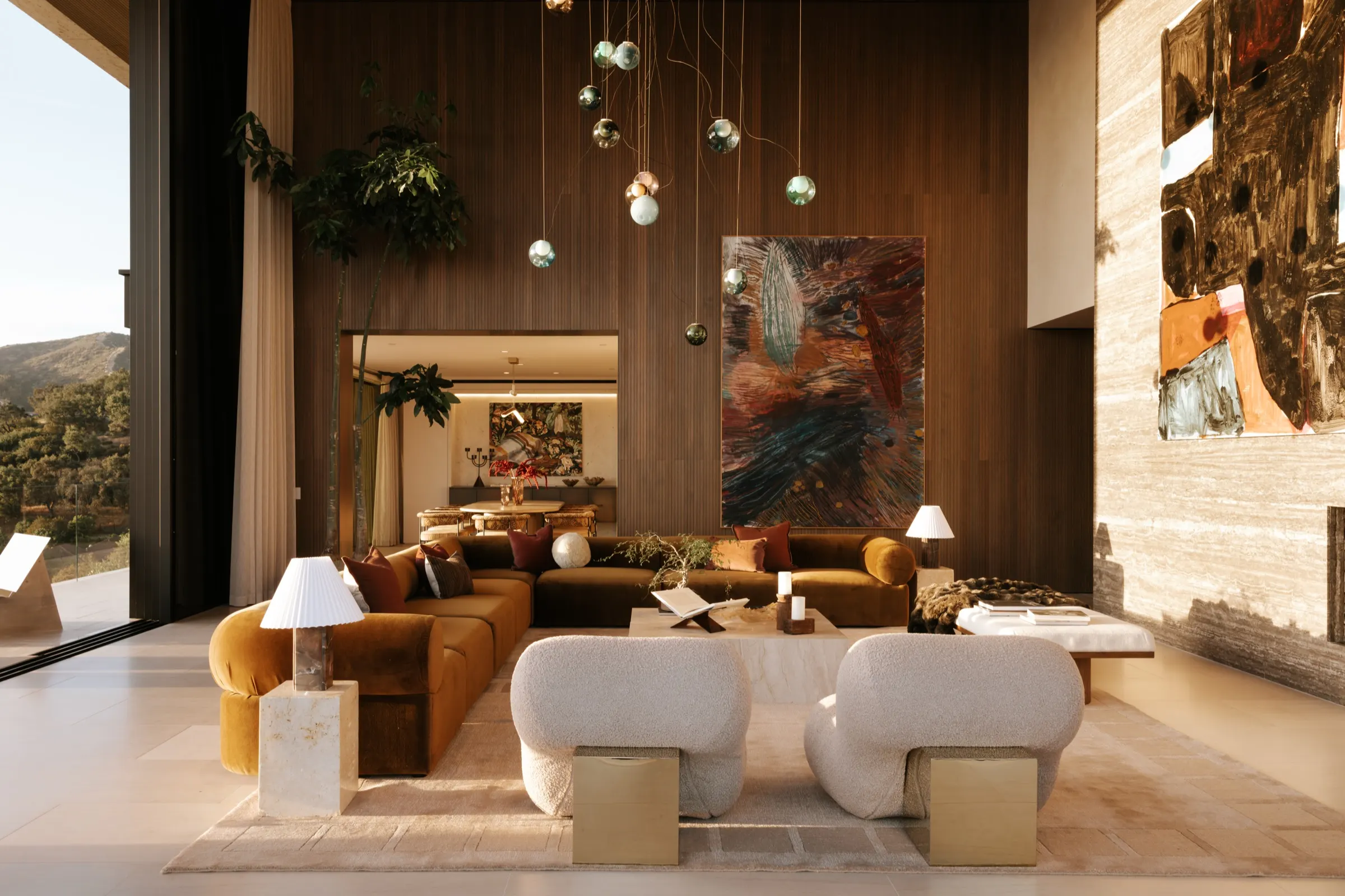 The Getty House, Brentwood — great room seating under the walnut wall and art