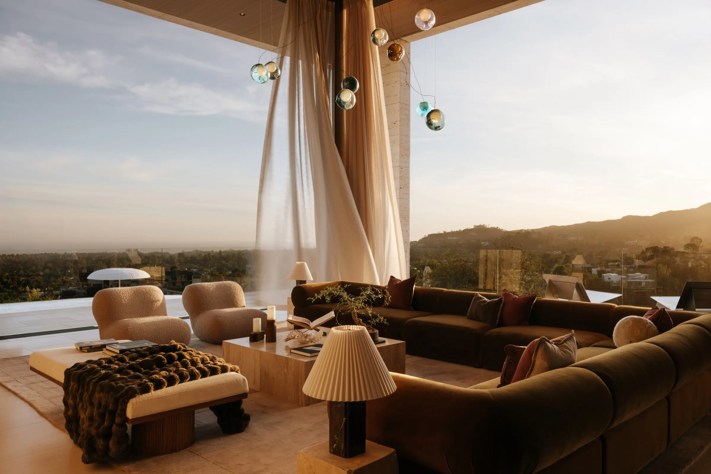 The Getty House, Brentwood — great room open to the terrace at sunset