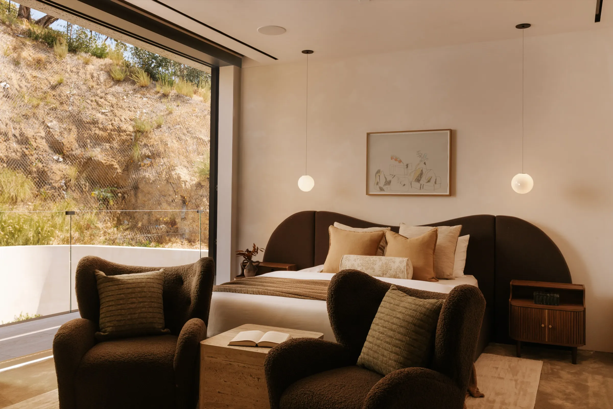 The Getty House, Brentwood — guest bedroom with a glass wall to the hillside