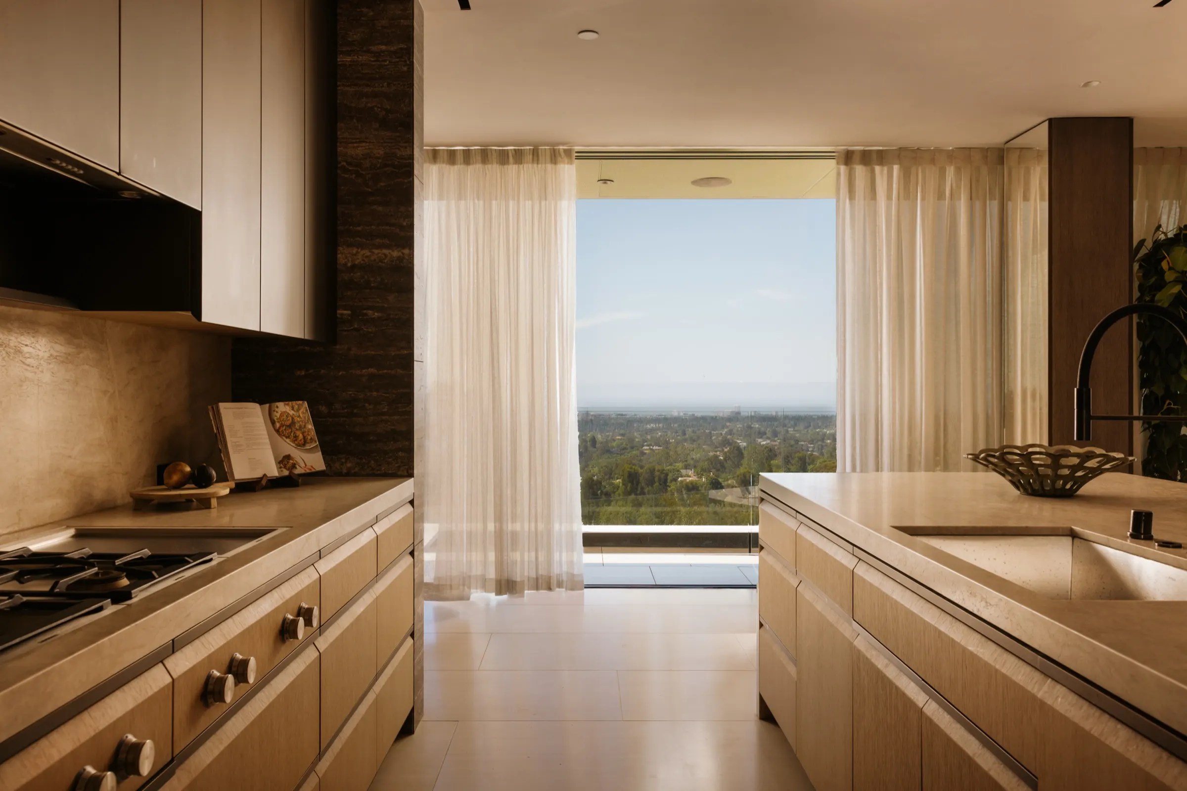 The Getty House, Brentwood — dual kitchen islands with the city beyond