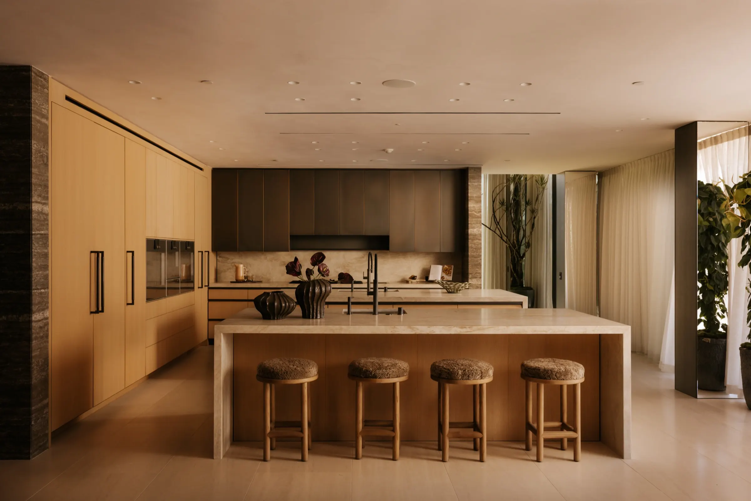 The Getty House, Brentwood — kitchen with stone island, leather stools and white oak cabinetry