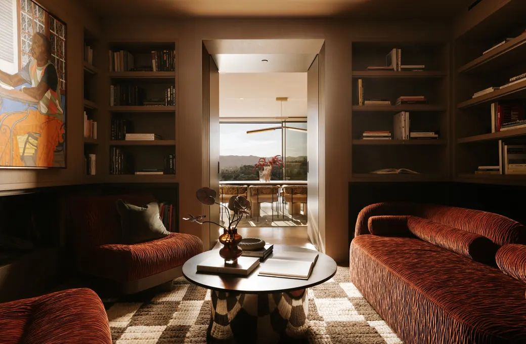 The Getty House library with velvet sofas and built-in bookshelves