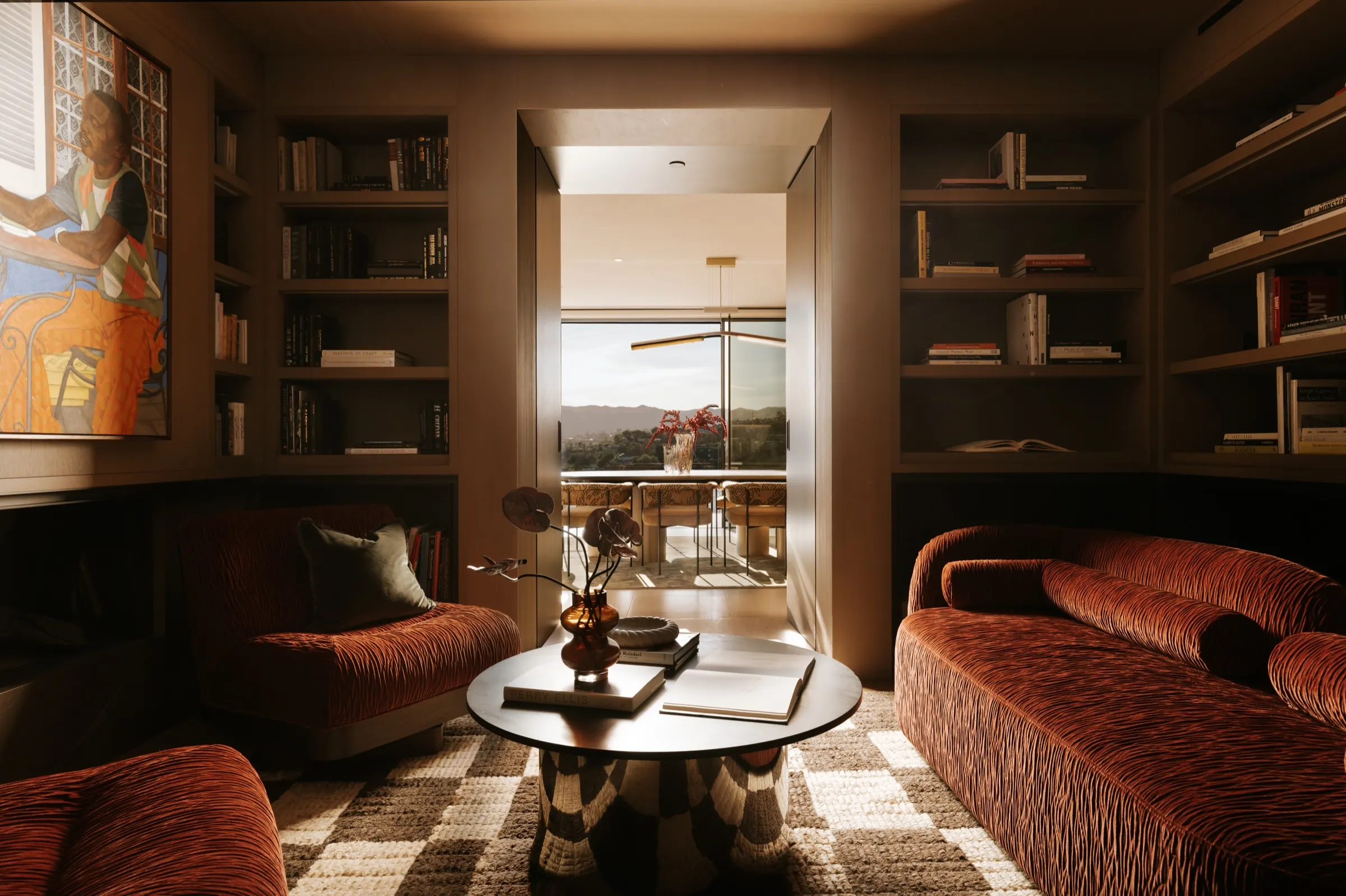 The Getty House, Brentwood — library with velvet sofas and built-in bookshelves