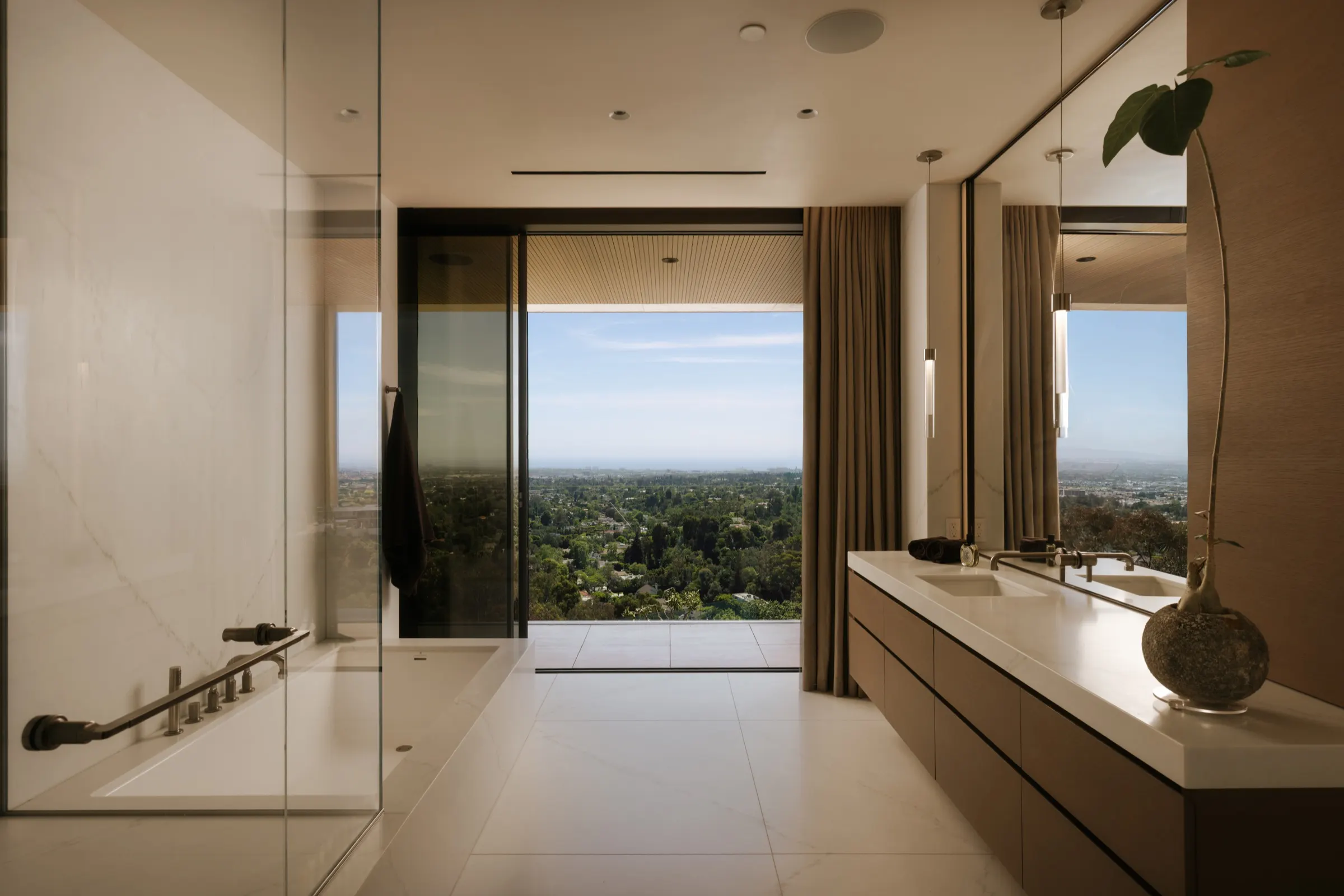 The Getty House, Brentwood — primary bath with floating vanity and glass shower