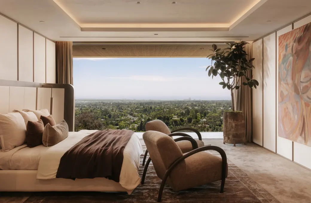 The Getty House primary suite open to a panoramic city view