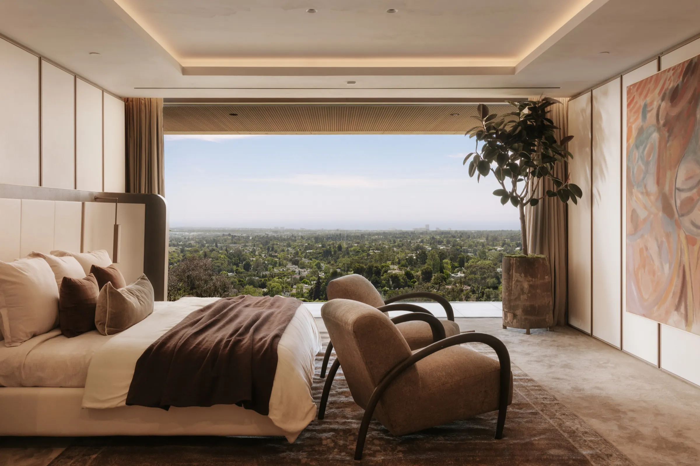 The Getty House, Brentwood — primary suite open to a panoramic city view