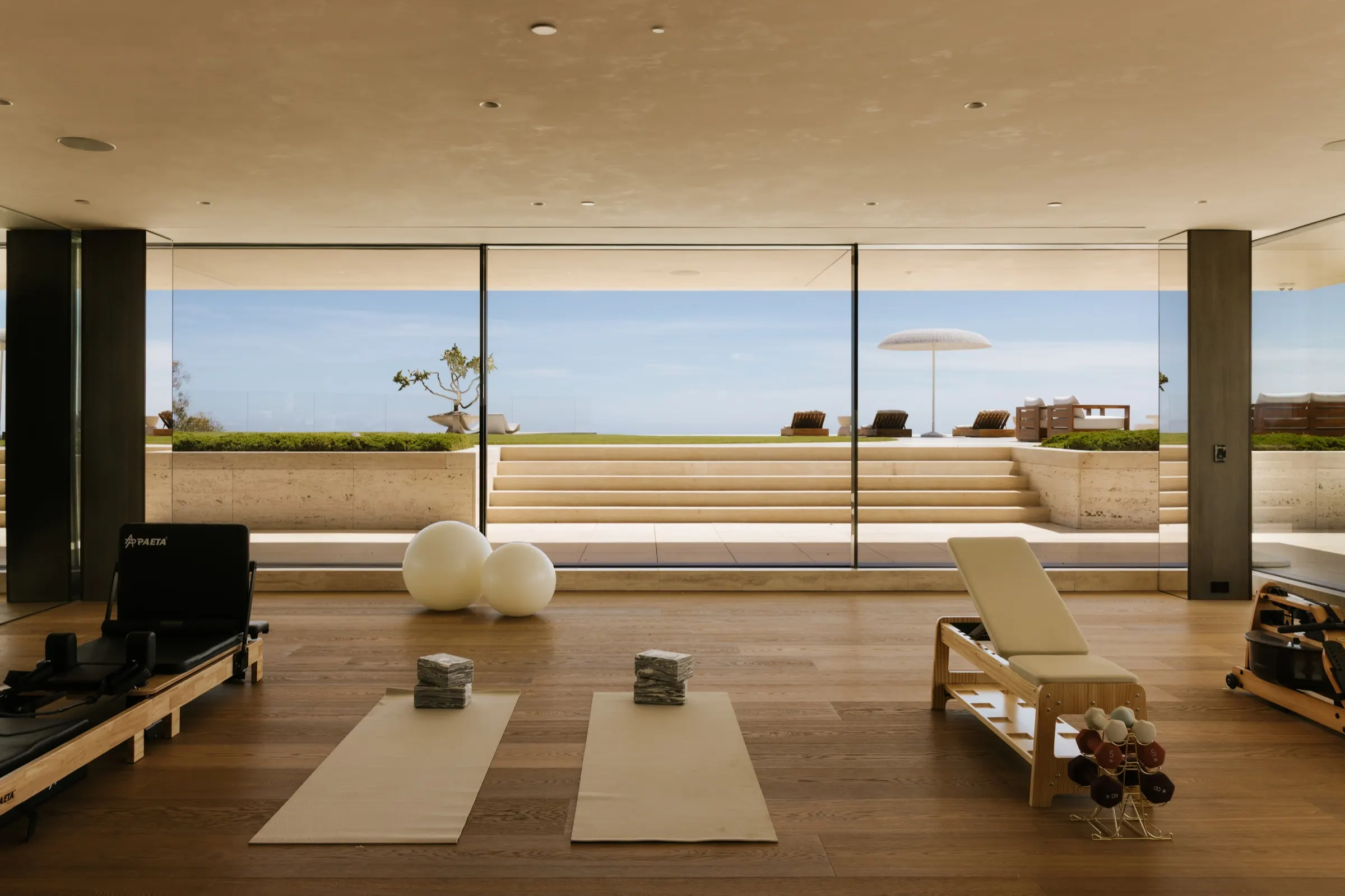 The Getty House, Brentwood — wellness studio with a glass wall to the lawn