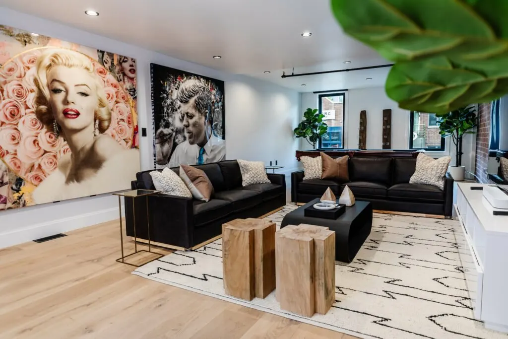 Main Street — media lounge with leather sofas and pop-art gallery wall