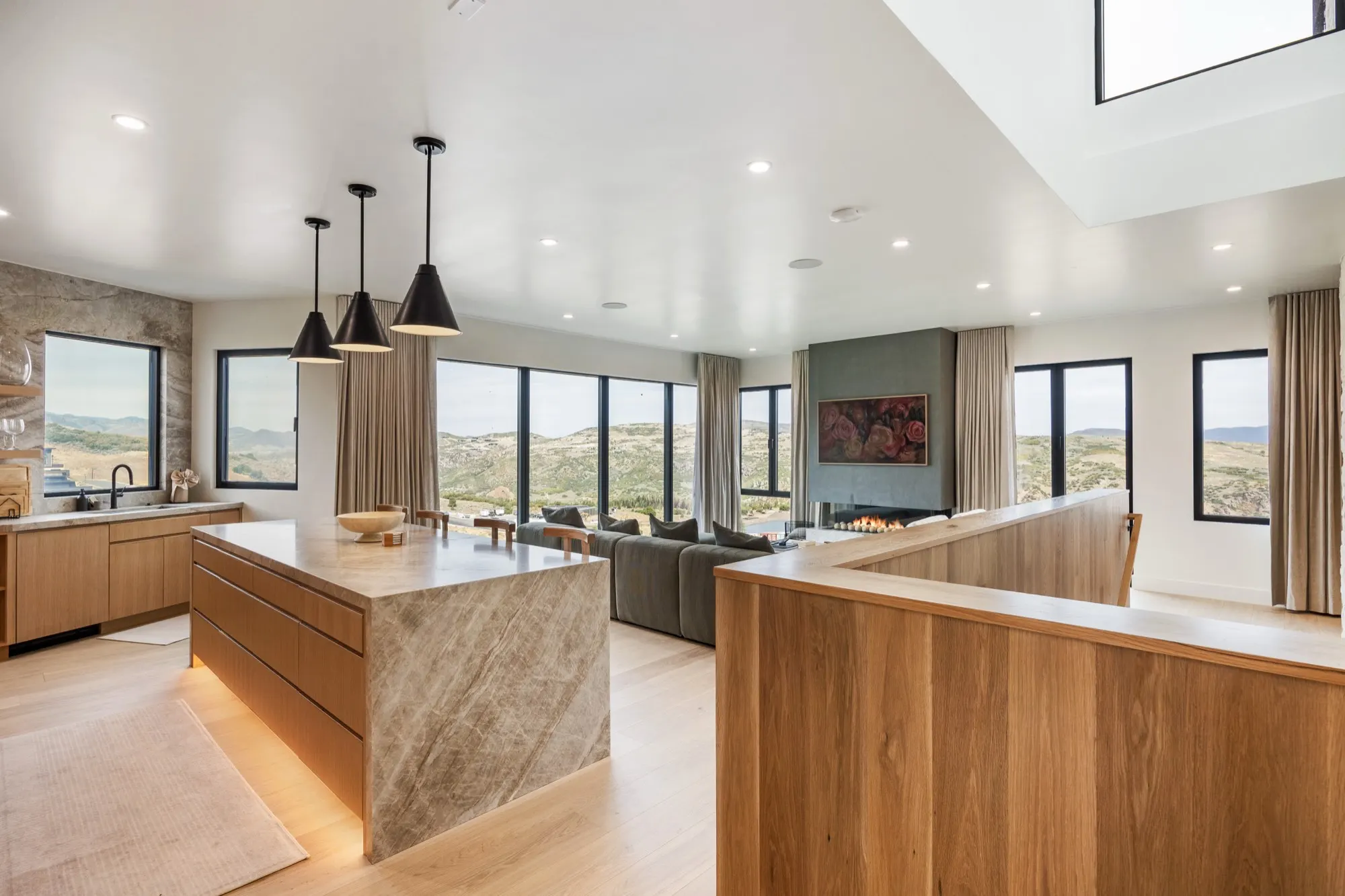 Islay Way — open great room with quartzite island and valley view wall
