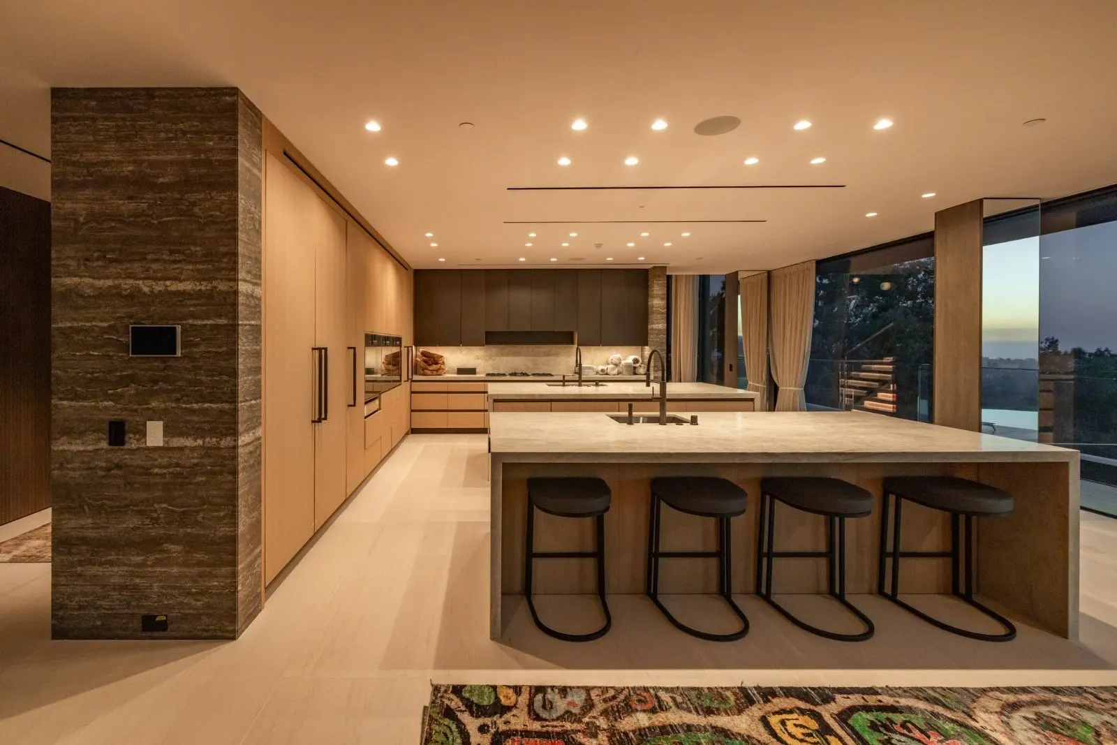 Getty House — dual-island kitchen with stone cladding and Gaggenau appliances