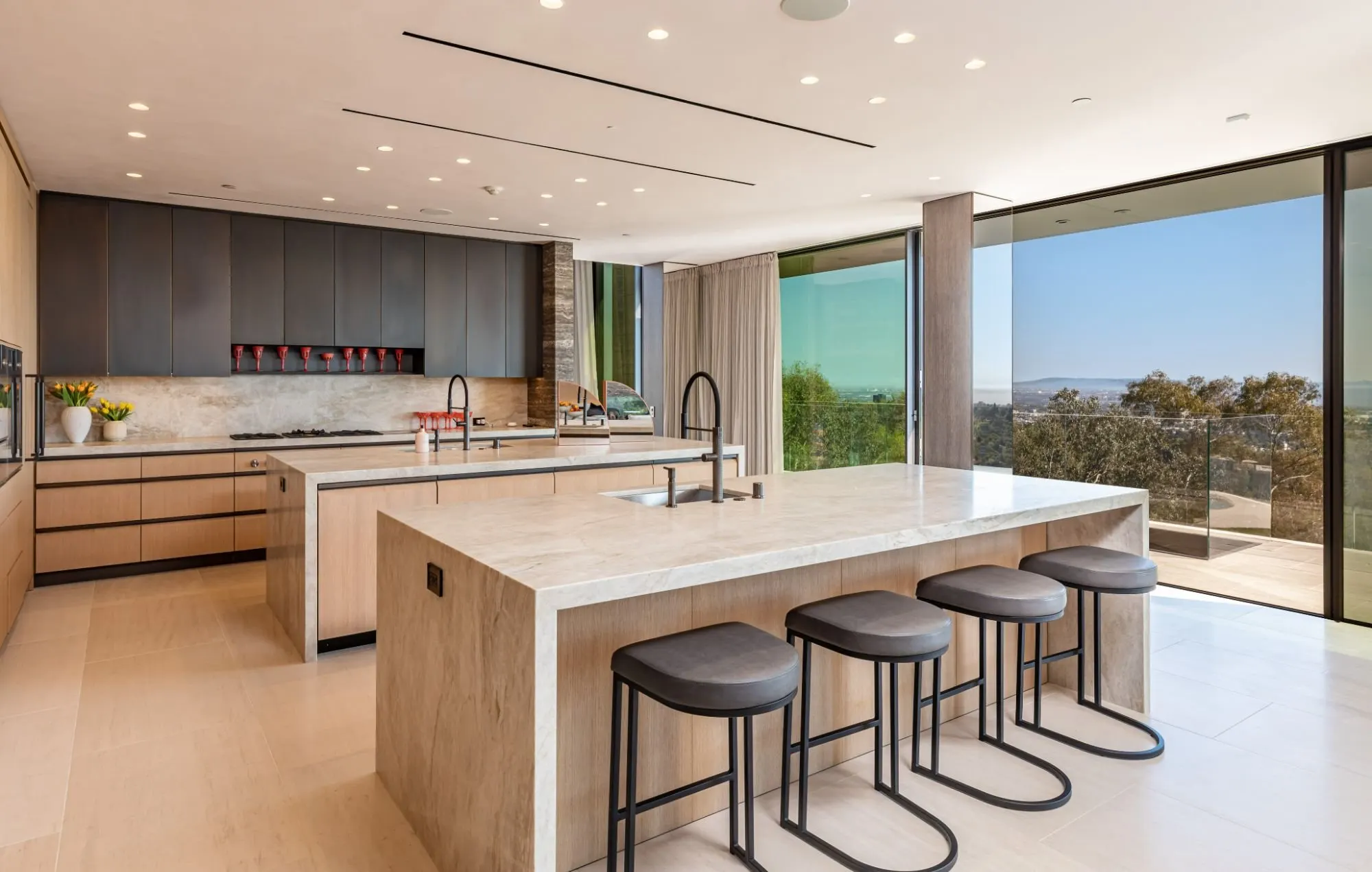 Getty House — kitchen with wood cabinetry and stone waterfall counters