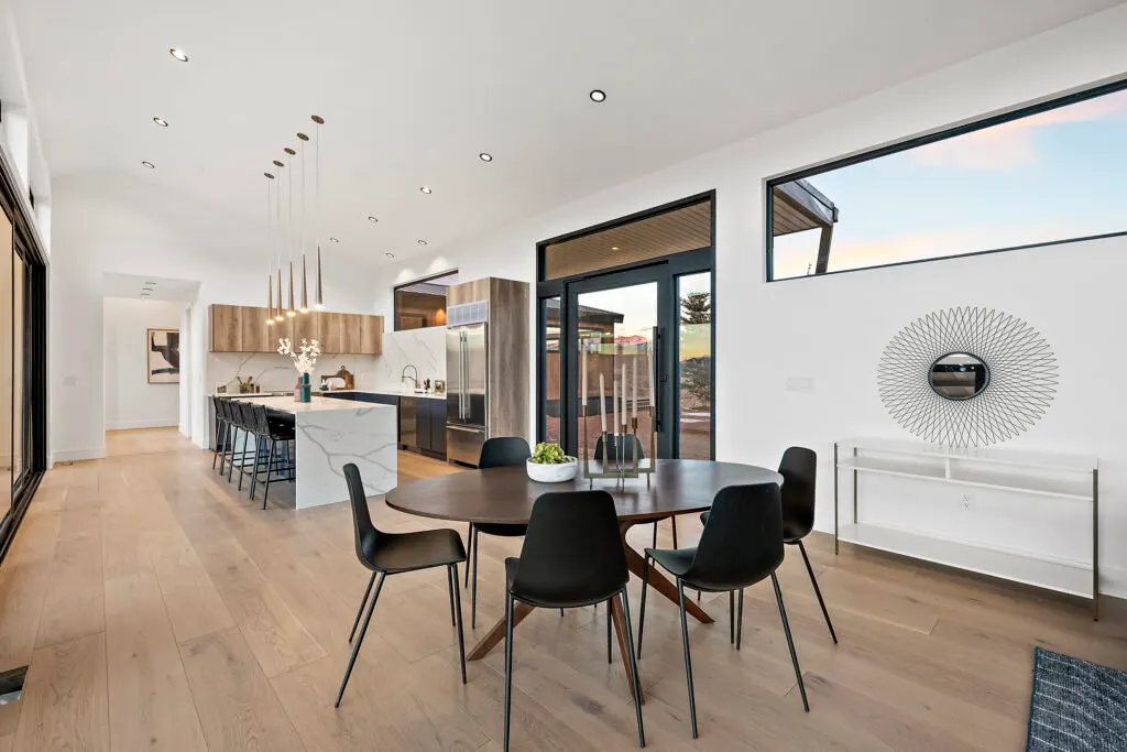 Icon Haus — open-concept kitchen and dining with black window frames