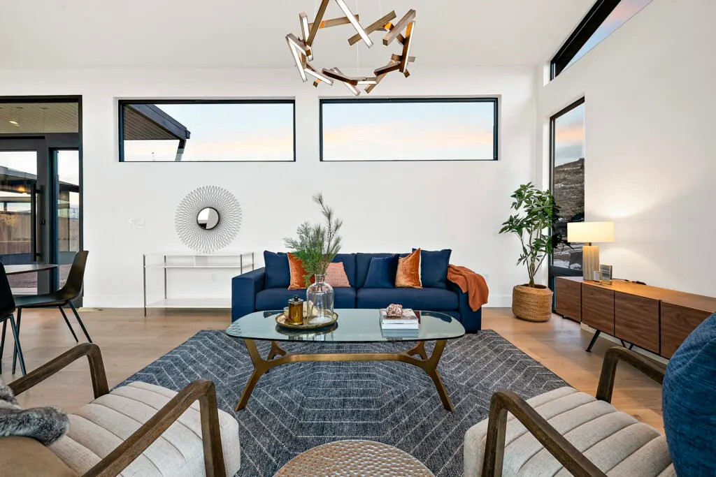 Icon Haus — living room with navy sofa, sculptural chandelier and mid-century credenza