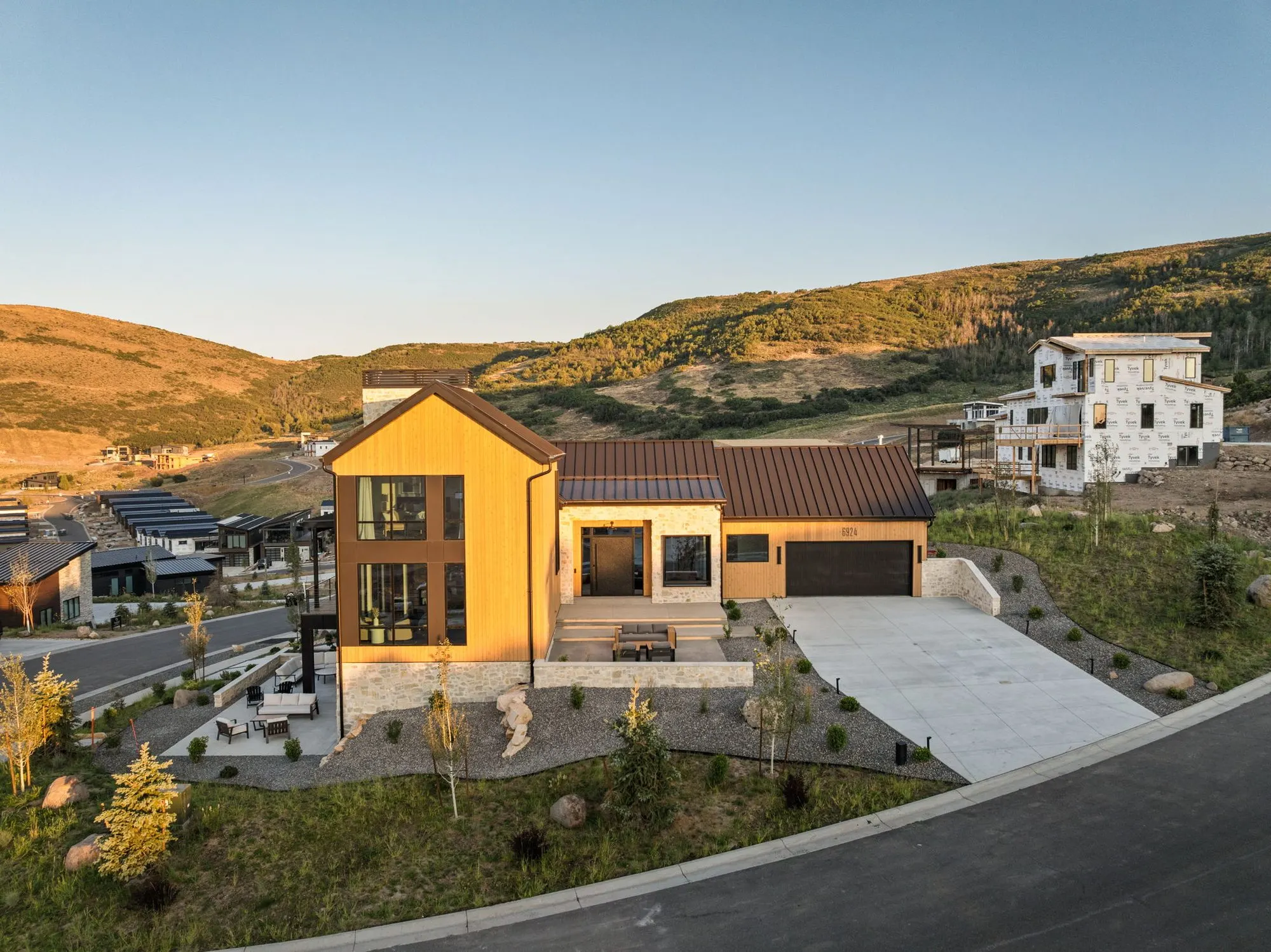 Lumen — aerial of the front elevation at dusk, Benloch Ranch, Heber City