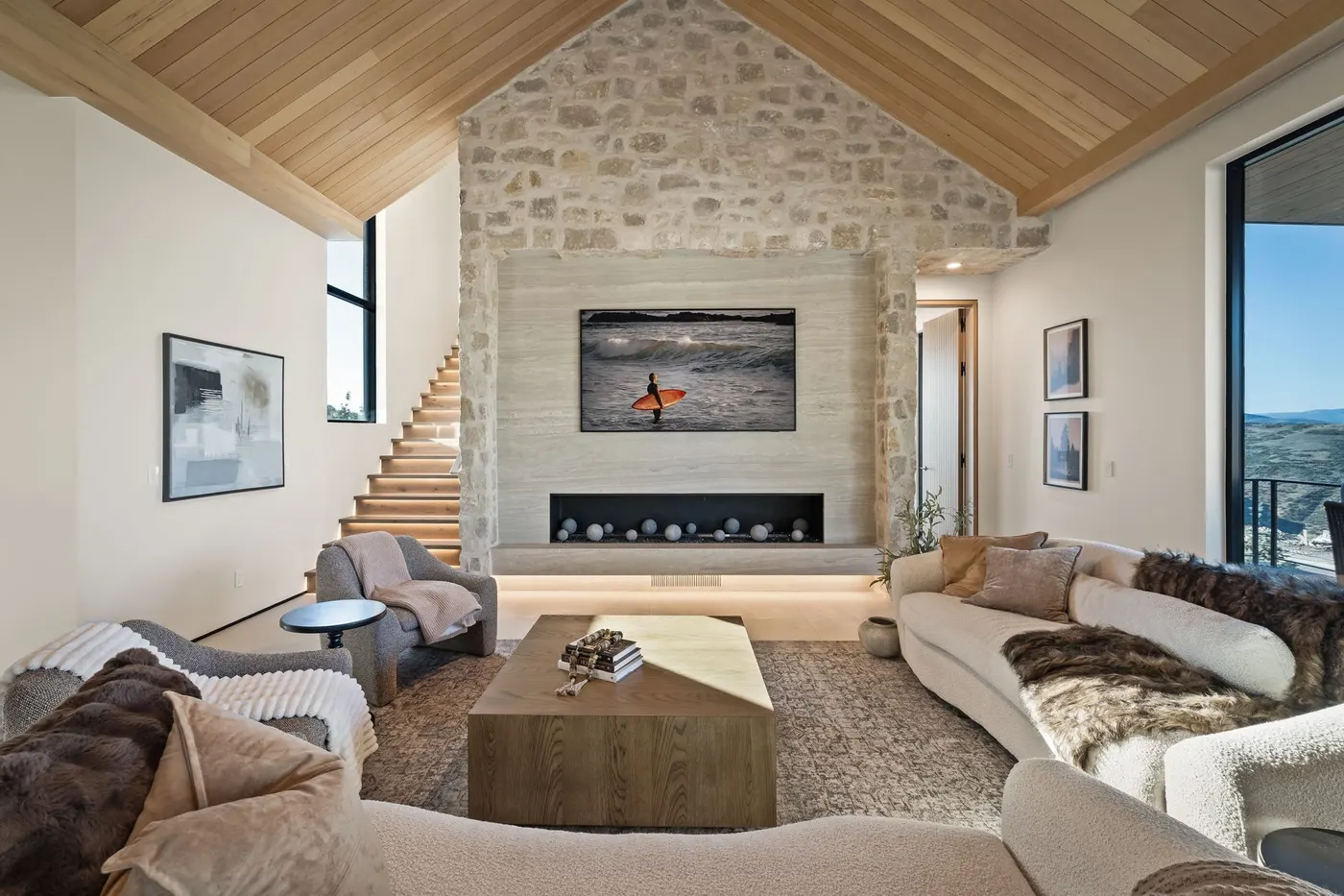 Vaulted cedar ceiling and full-height stone fireplace at Lumen