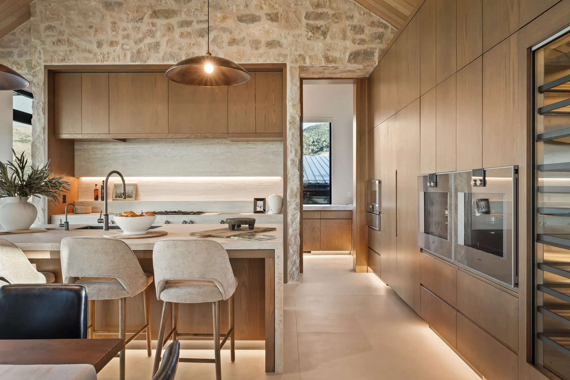 Lumen — kitchen island looking toward the wine wall and double ovens