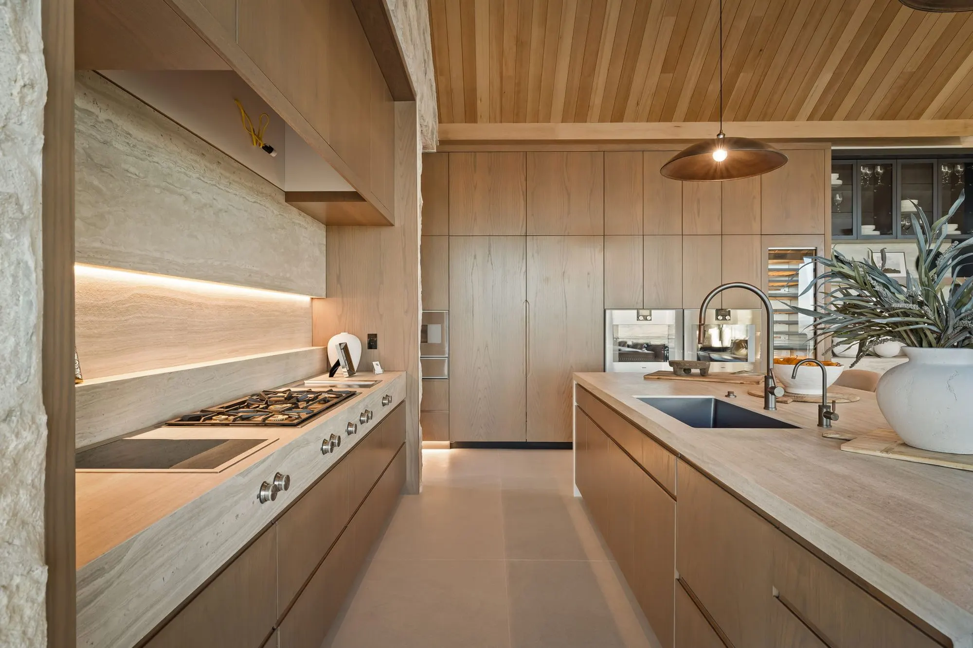 Lumen — kitchen range wall in white oak with an integrated hood