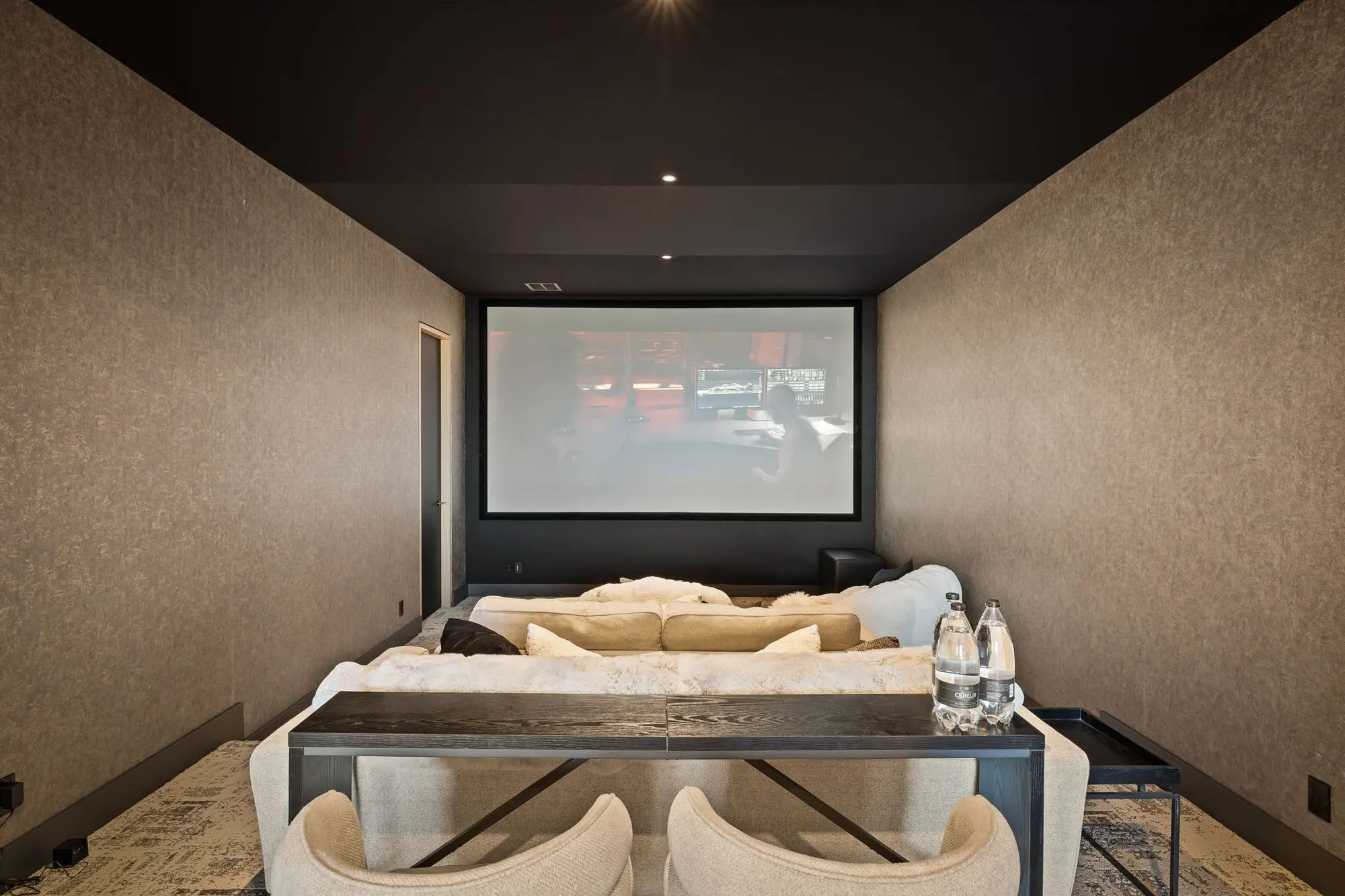 Lumen — theater room with projection screen and lounge seating