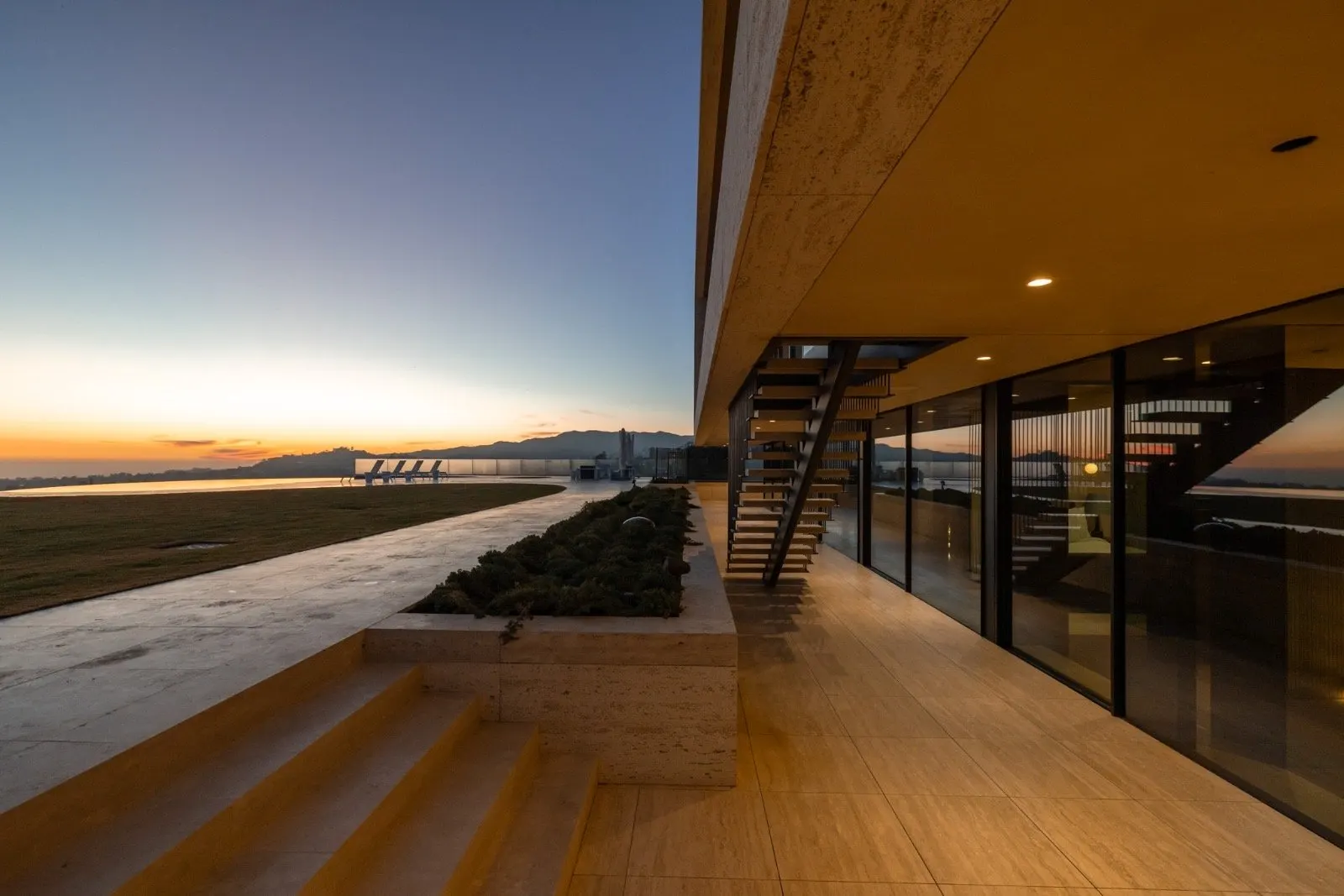 Getty House — sunset patio with floating staircase and ocean view