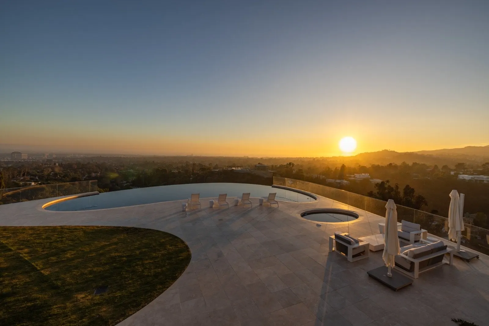 Getty House — pool terrace lounge with panoramic city view at sunset
