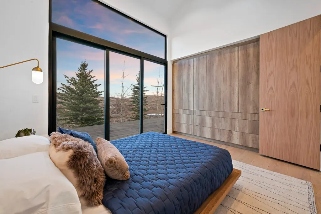 Icon Haus — master bedroom with sliding door to the mountain view
