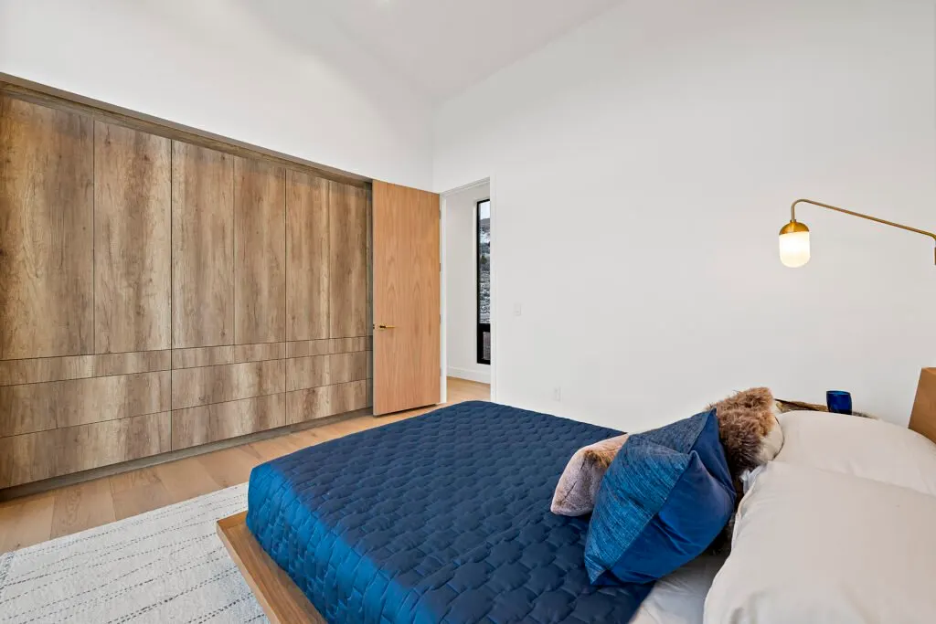 Icon Haus — full-wall built-in wood wardrobe, custom cabinetry
