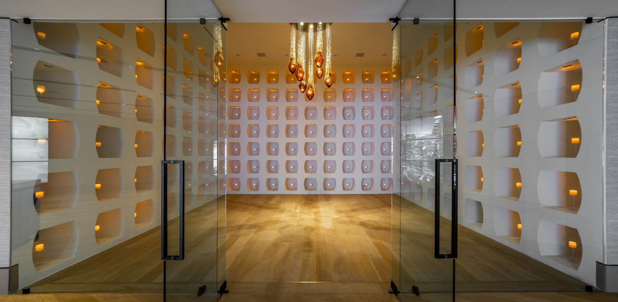 Flicker Estate — entry gallery, sculpted wall and glass pendants
