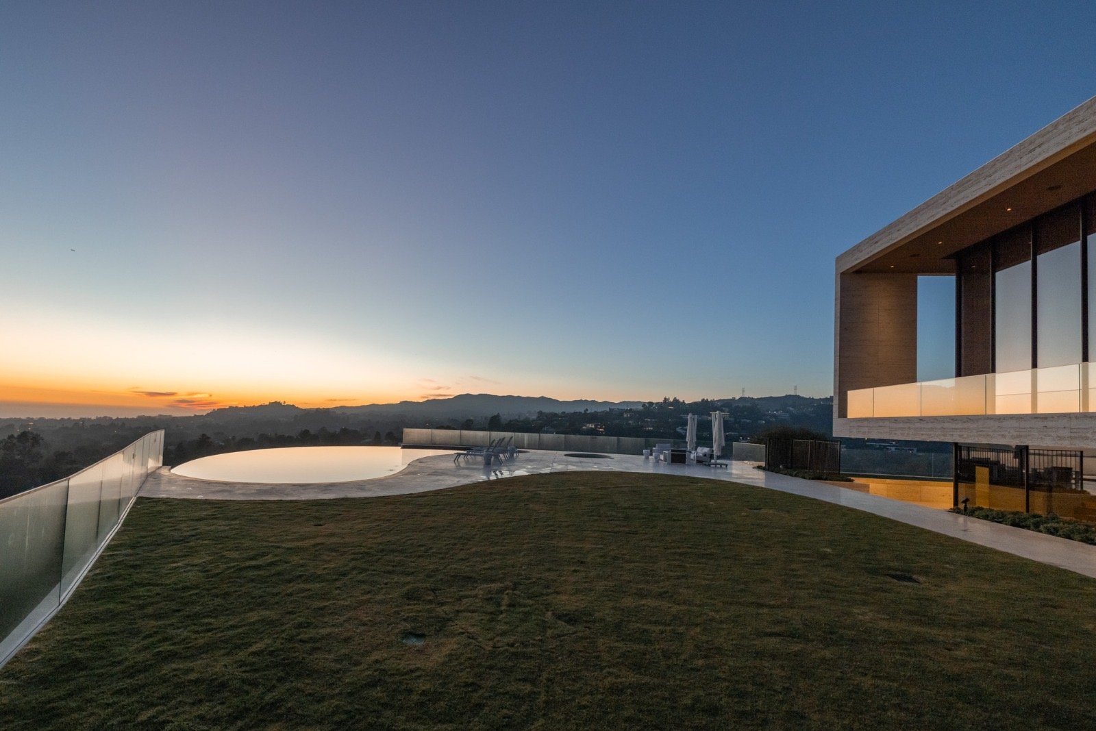 The Getty House — 684 Firth Brentwood CA LA Exterior Infinity Pool Lawn Travertine Facade Sunset View  Modern Home