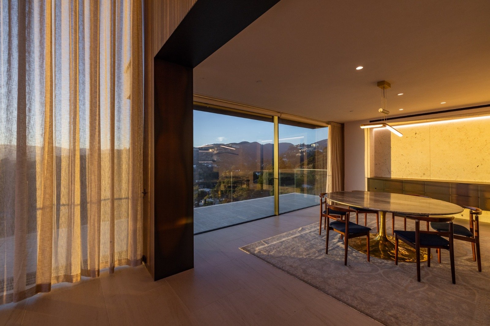 Getty House — dining room with oval marble table and valley view