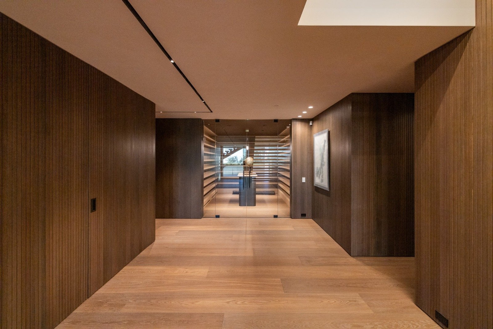 Getty House — entry hallway in wood paneling with wine cellar view
