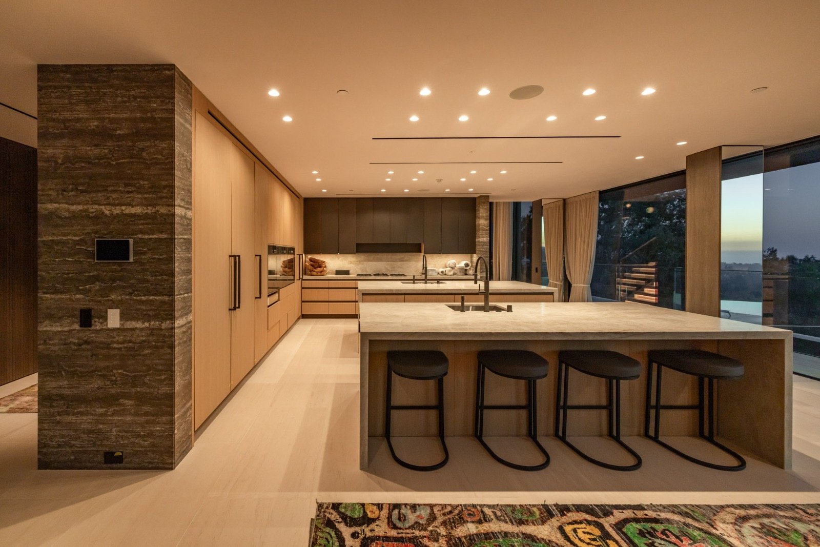 Getty House — dual-island kitchen with stone cladding and Gaggenau appliances