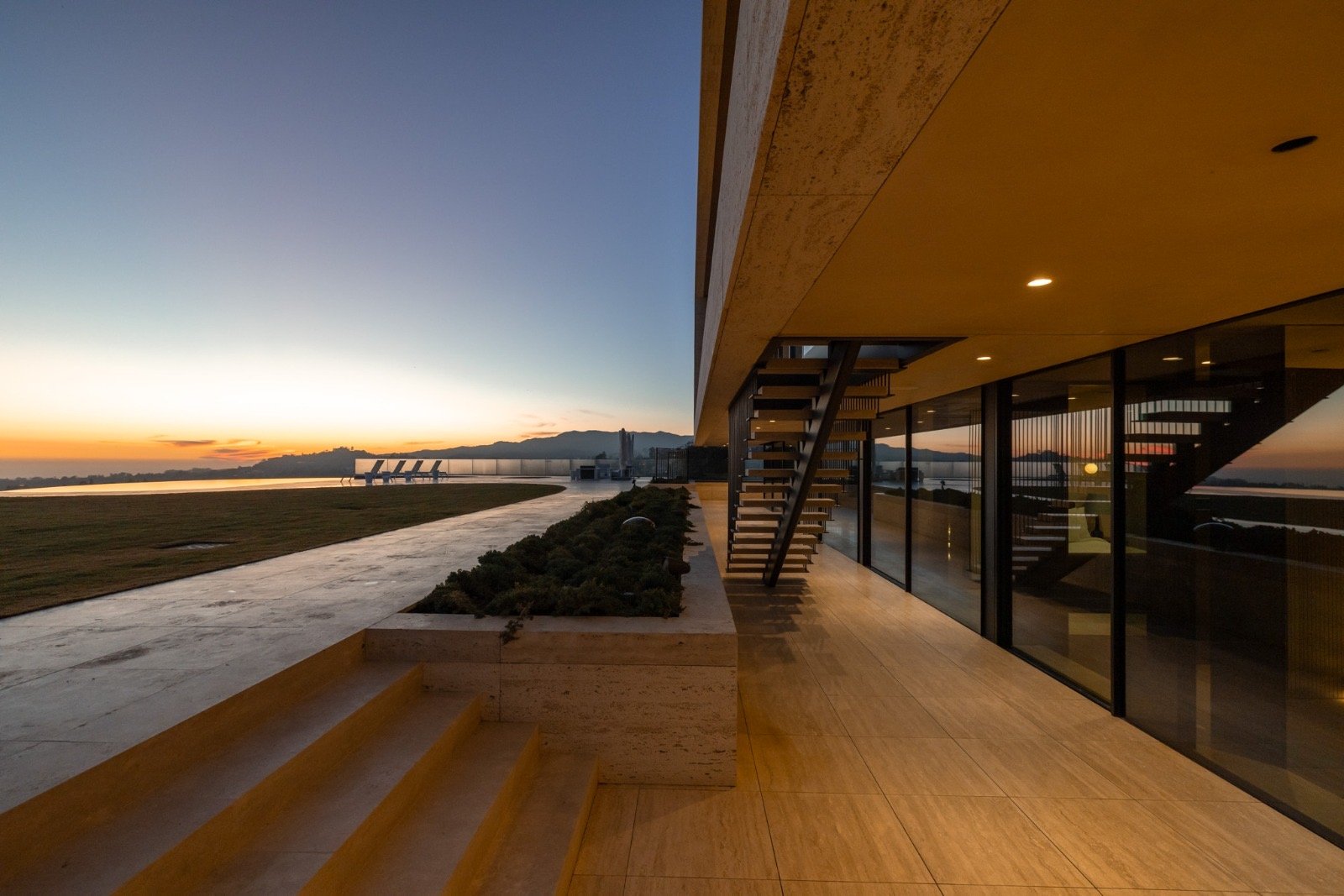 Getty House — sunset patio with floating staircase and ocean view