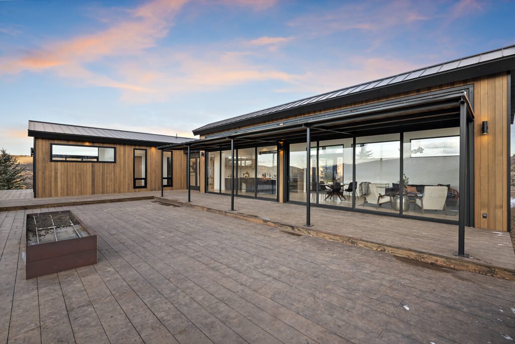 Icon Haus — covered patio and wood deck at sunset