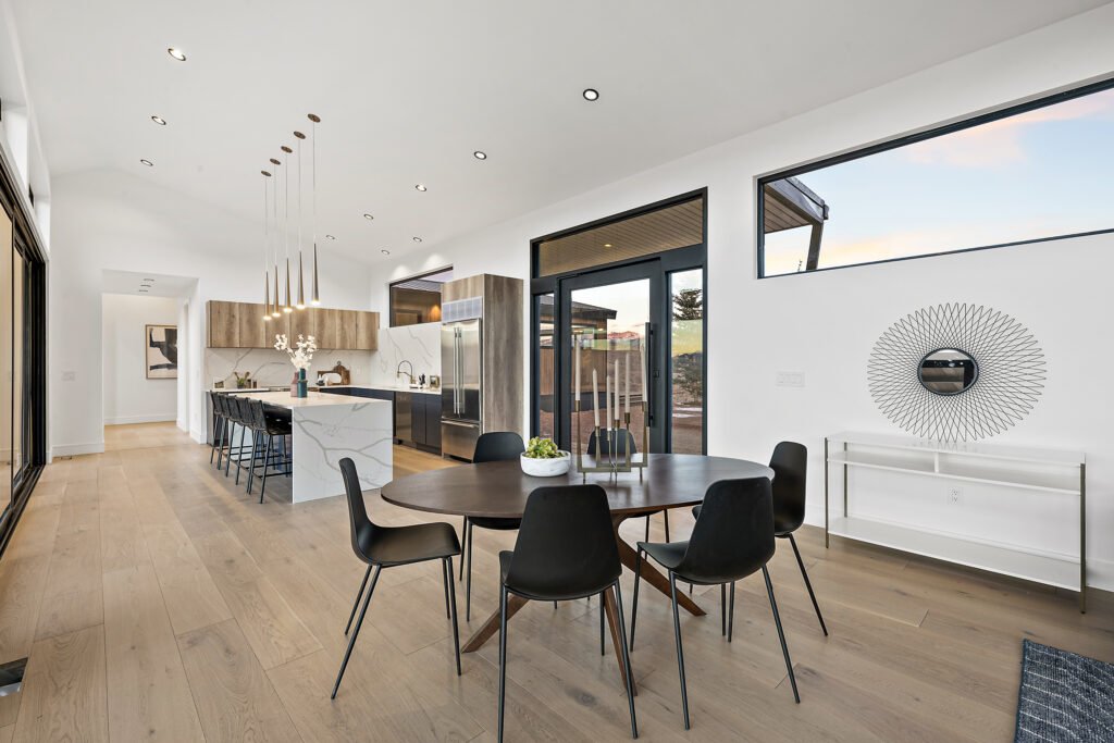 Icon Haus — open-concept kitchen and dining with black window frames