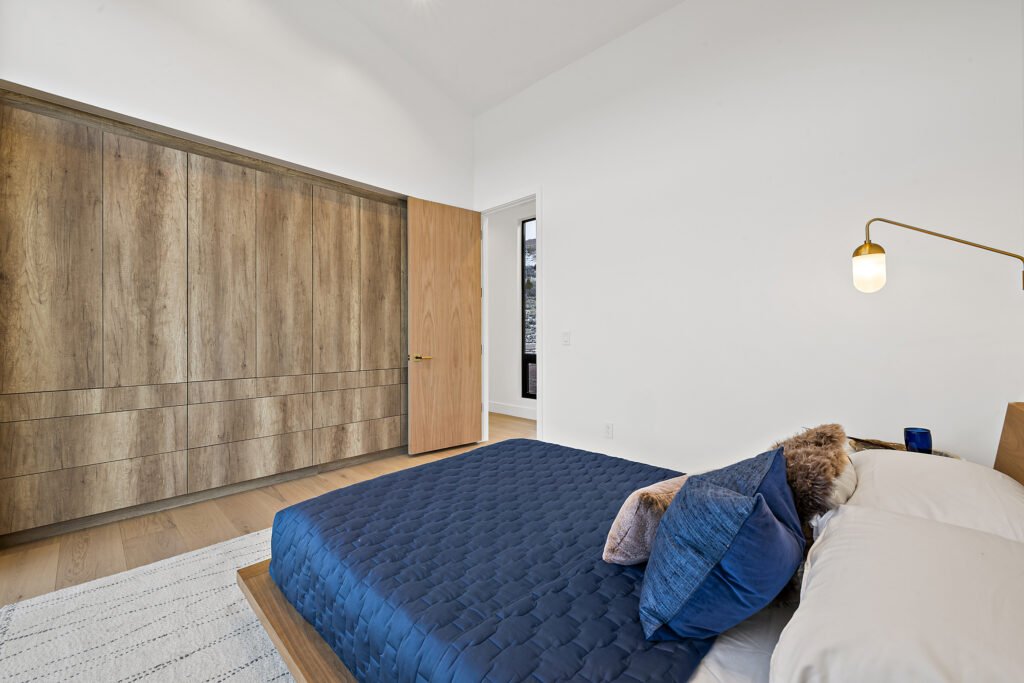 Icon Haus — full-wall built-in wood wardrobe, custom cabinetry