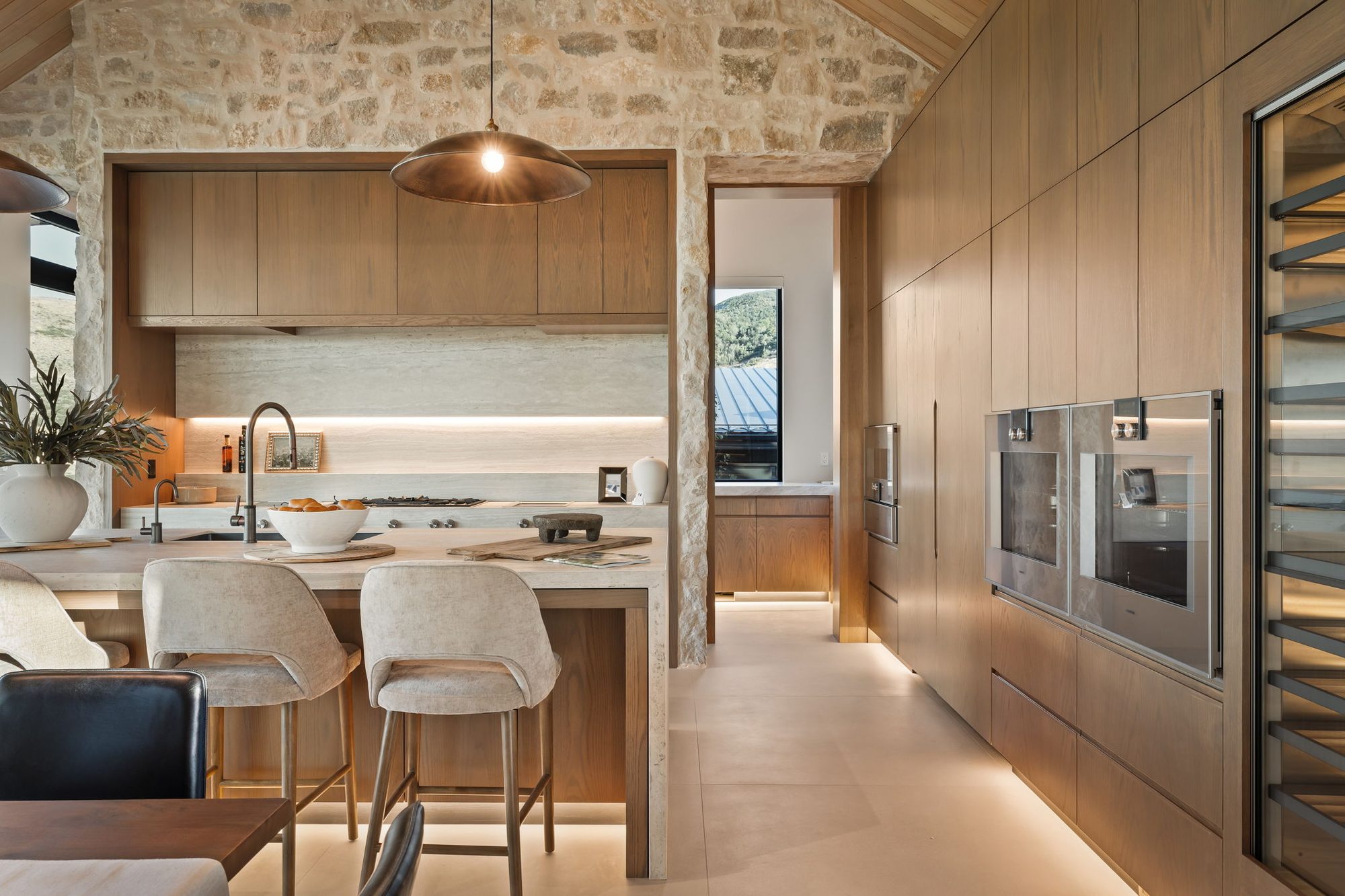 Lumen — kitchen island looking toward the wine wall and double ovens