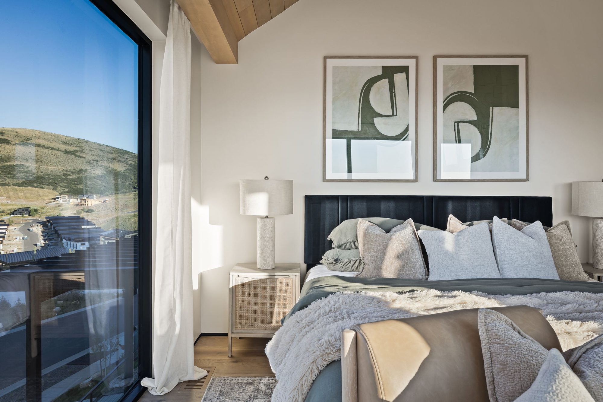 Lumen primary suite — corner glass to the valley, by Roderick Builders
