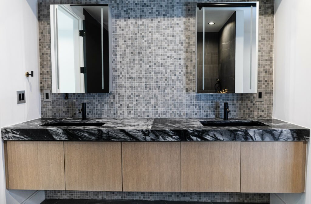 Main Street — double vanity in black marble with mosaic tile wall